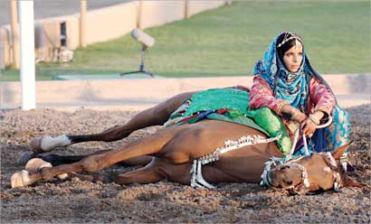 تجلس بجوار جوادها المتمدّد