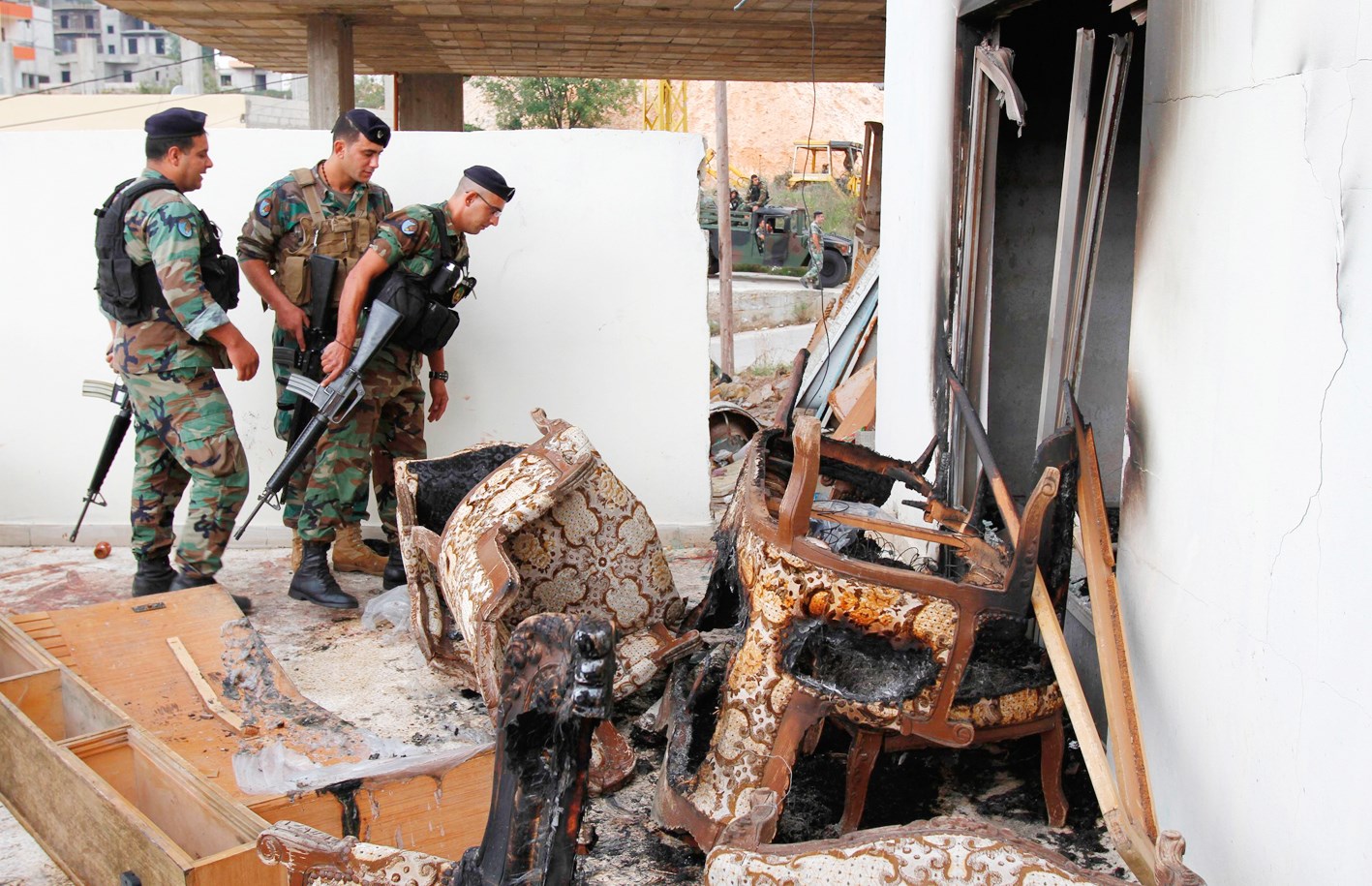 جنود من الجيش اللبناني يفتشون الشقة التي جرت مداهمتها في الضنية  (رويترز)