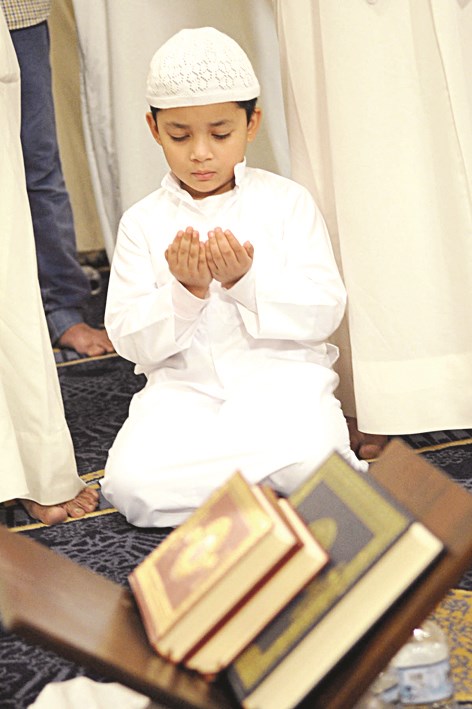 طفل يشارك الكبار الدعاء