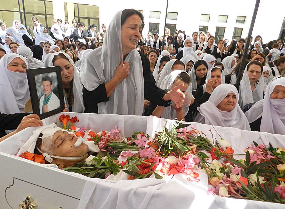 والدة الجندي خلدون حمود الذي قتل في عرسال تبكي فوق جثمانه خلال تشييعه في منطقة راشيا الوادي امس    (ا ف ب)