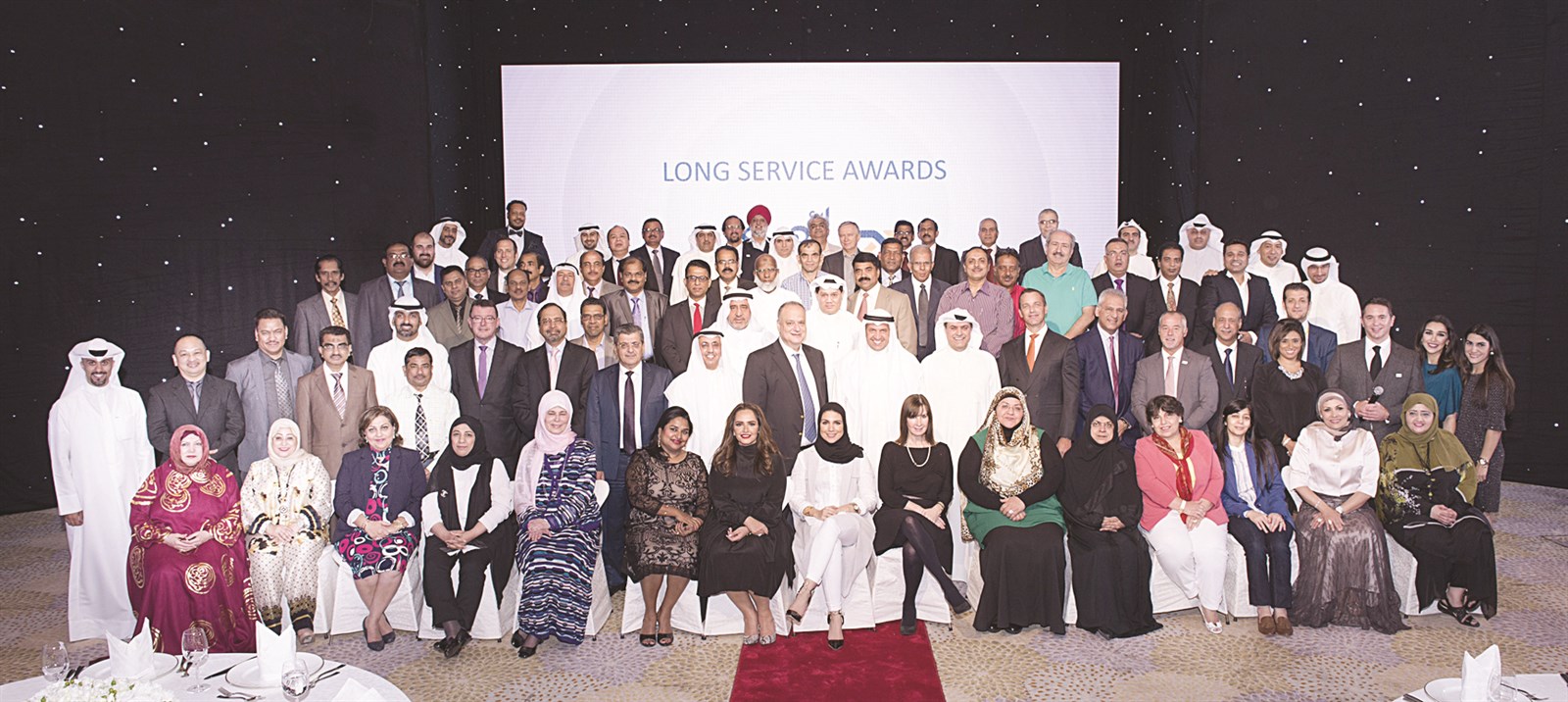 العقاد وعبدالله السميط وفوزي الثنيان مع الموظّفين المكرّمين