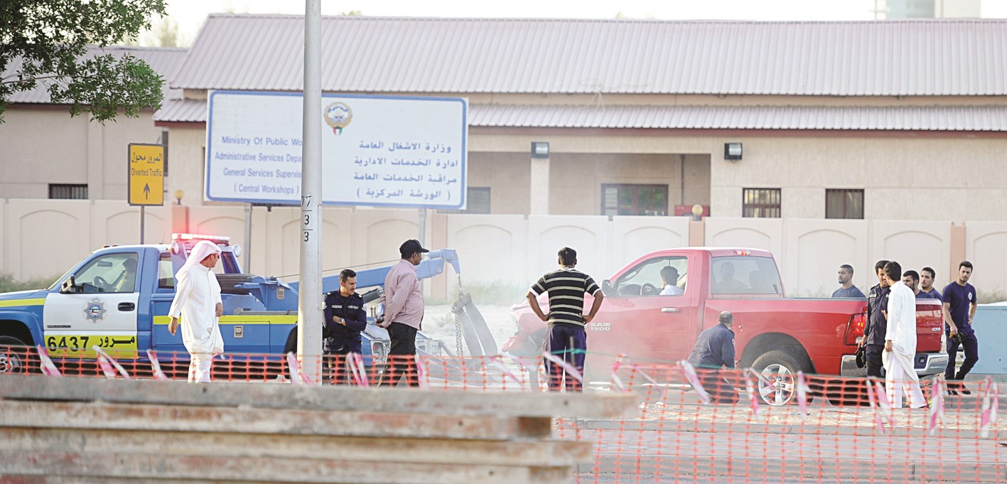 رجال المرور خلال إزاحتهم للسيارات التي عرقلت الطريق