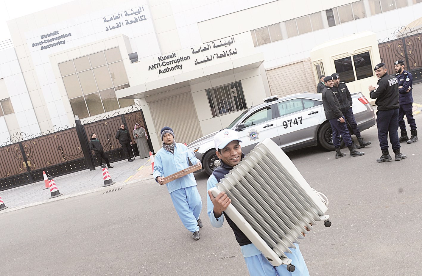 العمال ينقلون متعلقات الموظفين ومن ضمنها دفاية