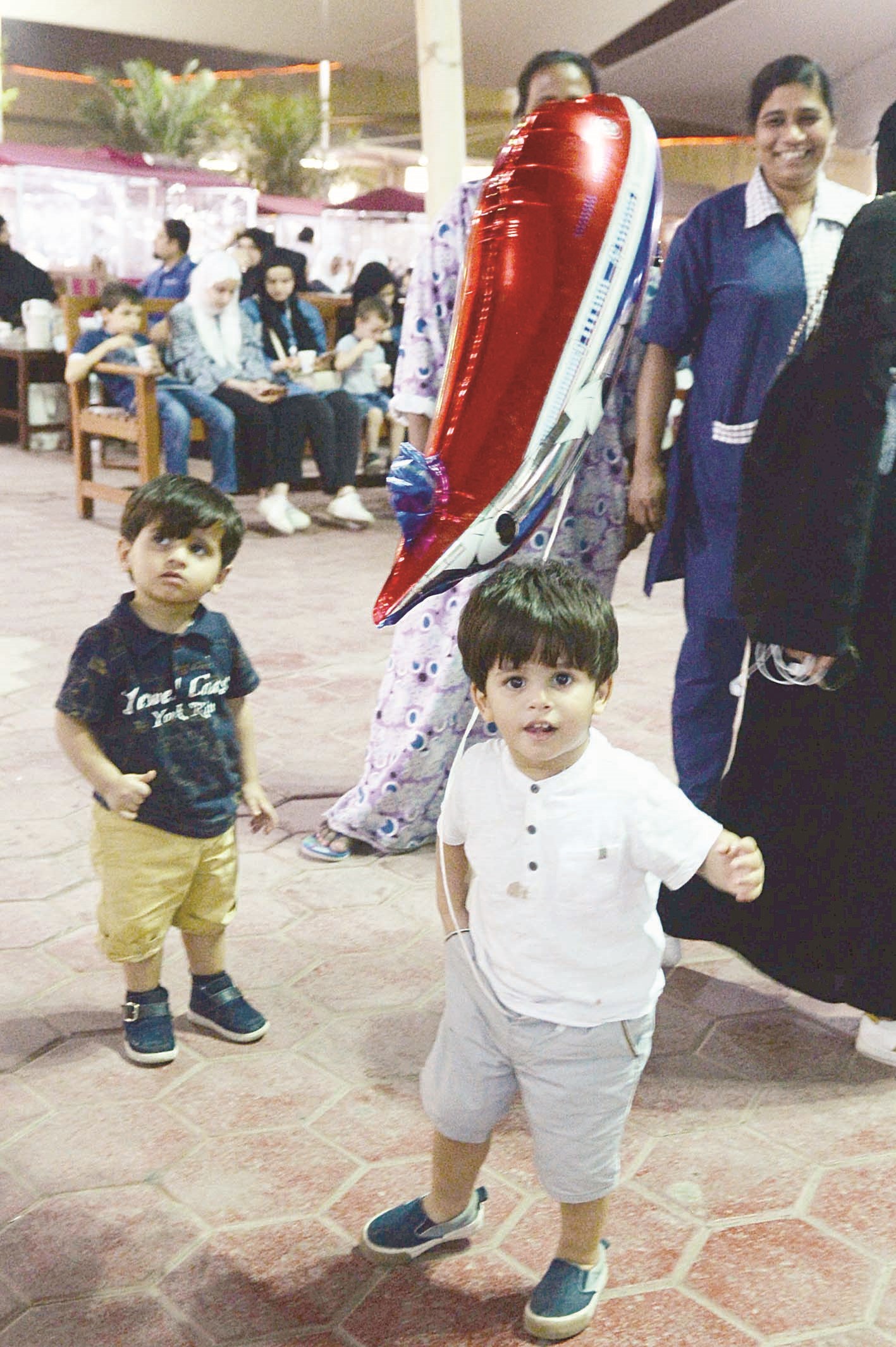 طفلان يلهوان في المقهى