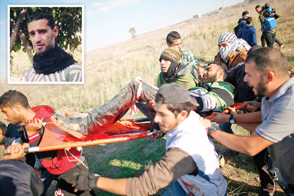 u0641u0644u0633u0637u064au0646u064au0648u0646 u064au062du0645u0644u0648u0646 u0623u062du062f u0627u0644u062cu0631u062du0649 u0642u0631u0628 u0627u0644u0633u064au0627u062c u0627u0644u062du062fu0648u062fu064a u0645u0639 u0625u0633u0631u0627u0626u064au0644 u0634u0631u0642 u063au0632u0629u060c u0648u0641u064a u0627u0644u0625u0637u0627u0631 u0635u0648u0631u0629 u0627u0644u0634u0647u064au062f u0645u062du0645u0648u062f u0627u0644u0645u0635u0631u064at (u0623 u0641 u0628)