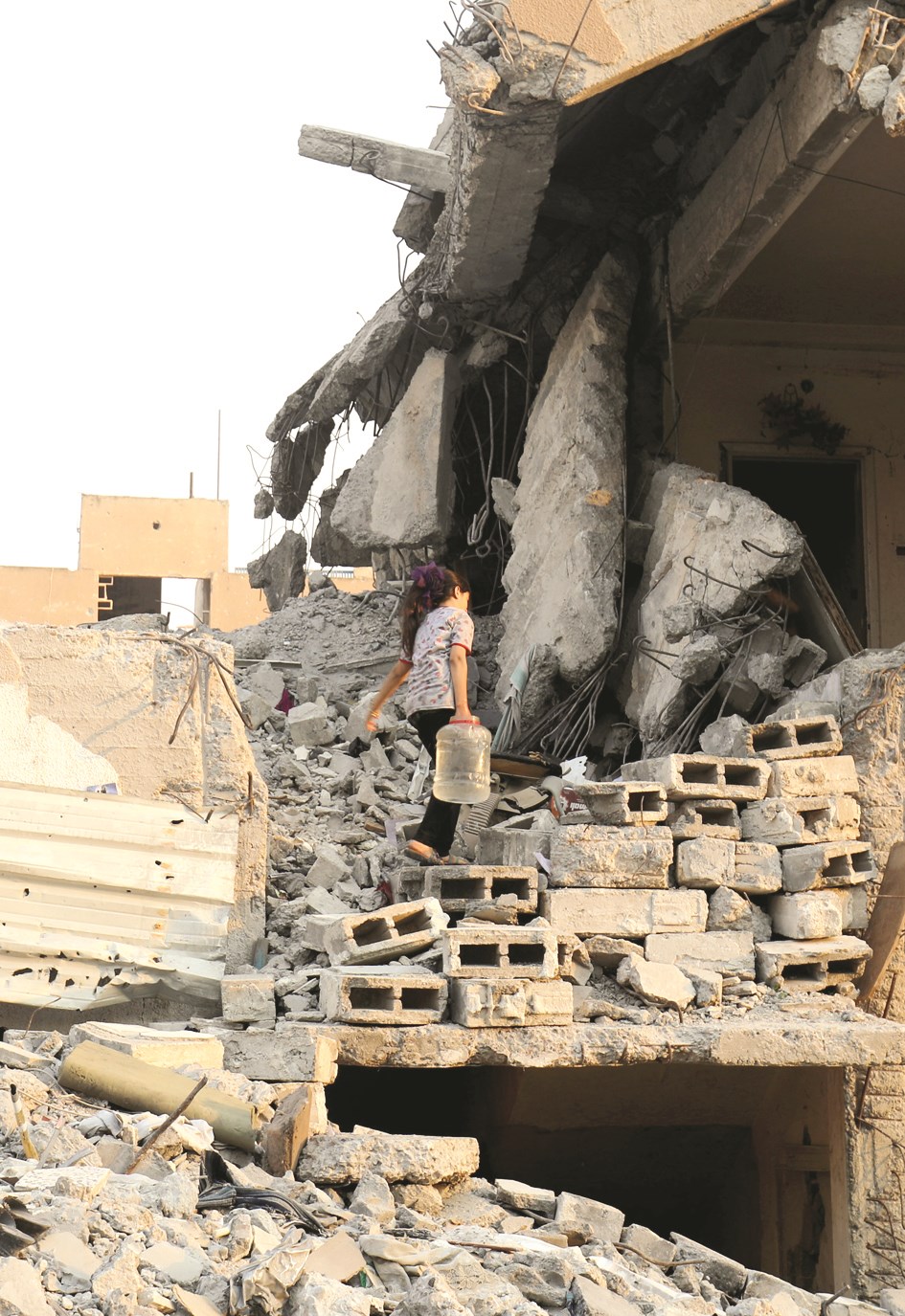 فتاة سورية في منزل شبه مدمر تقيم فيه مع عائلتها بمدينة الطبقة بعد فرارهم من الرقة (ا ف ب)