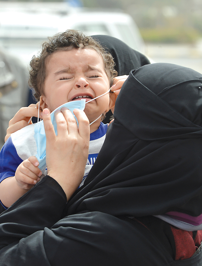 طفل متضايق من الكمامة