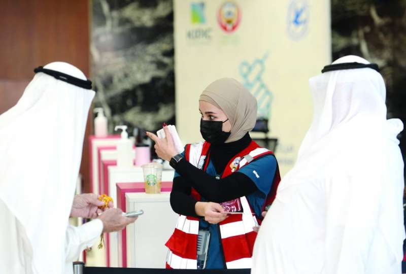 مساعدة متلقي اللقاح في مركز التطعيم بأرض المعارض (تصوير أسعد عبدالله)