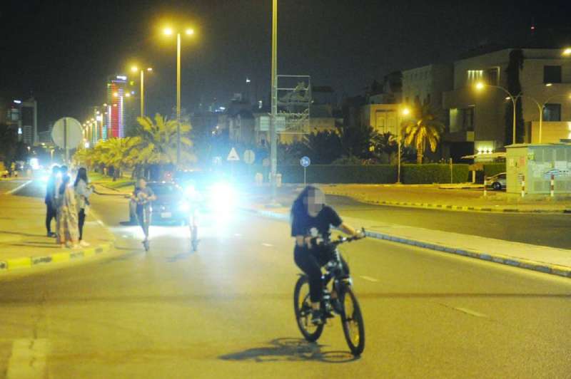 سكوتر ودراجات هوائية أمام سيارة في أحد الشوارع