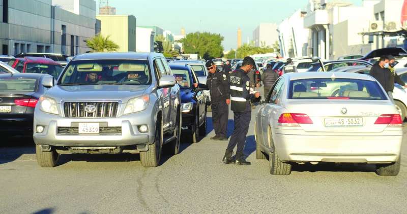 التدقيق على بيانات قائدي السيارات في الشويخ الصناعية 	(تصوير سعود سالم)
