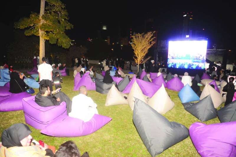 عدد من الجمهور يتابع الحفل عبر الشاشة	(تصوير سعود سالم)