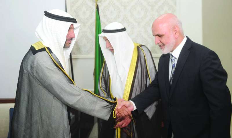 الغانم مصافحاً السفير الأفغاني وبينهما المذكور 