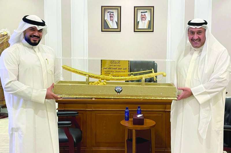 
فيصل الحمود متسلماً هدية تذكارية من الشاب علي الداغر
