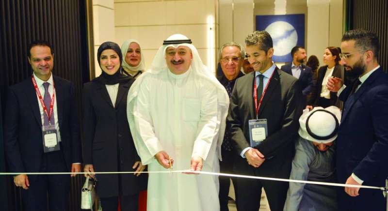 
العوضي خلال قص شريط افتتاح المعرض الملازم للمؤتمر