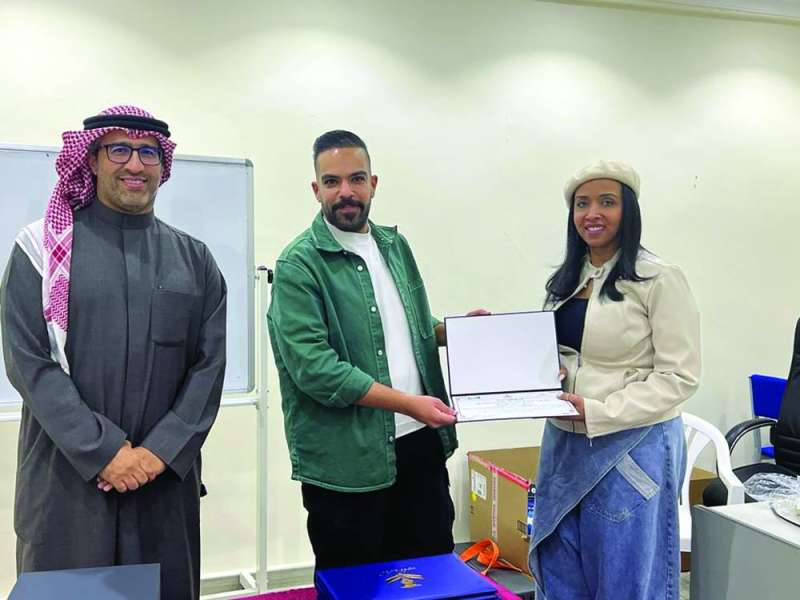 


الشطي مُكرّماً إحدى المُشاركات في الورشة بحضور حميدي المطيري 