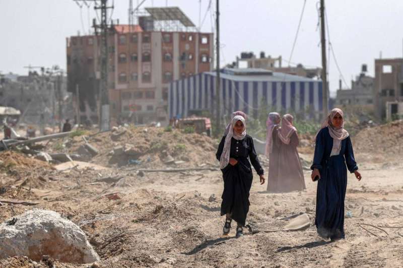 فلسطينيات وسط الركام في خان يونس (أ ف ب)
