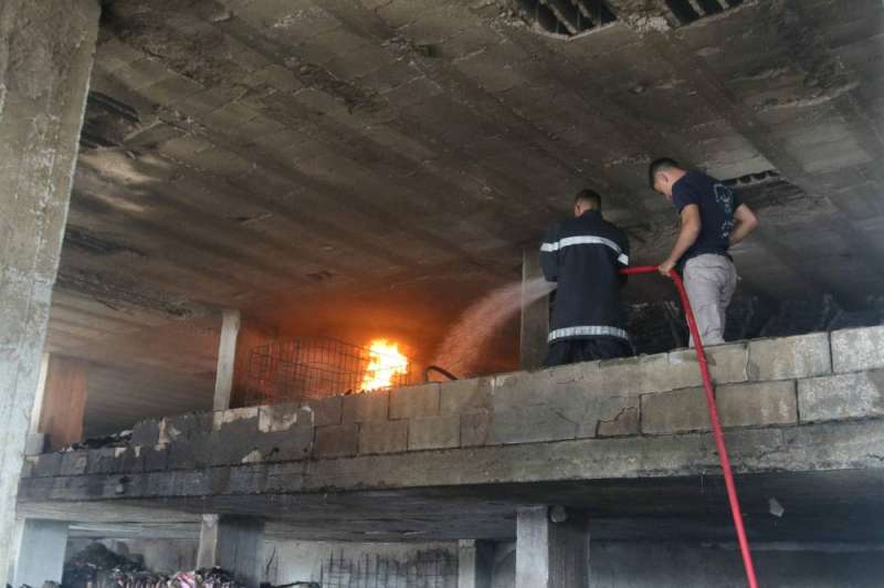 إخماد النار بمبنى في بلدة وادي جيلو جنوب لبنان (أ ف ب)