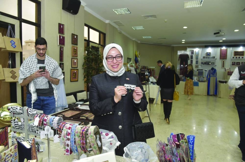 السفيرة التركية طوبي سونمز تستعرض إحدى المقتنيات بالمعرض