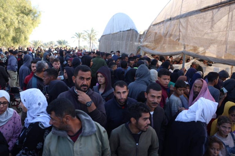 فلسطينيون ينتظرون الحصول على طحين في خان يونس  (أ ف ب)