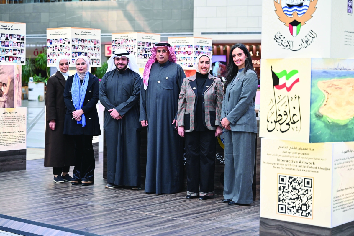 القائمون على المعرض بين اللوحات (تصوير أسعد عبدالله)