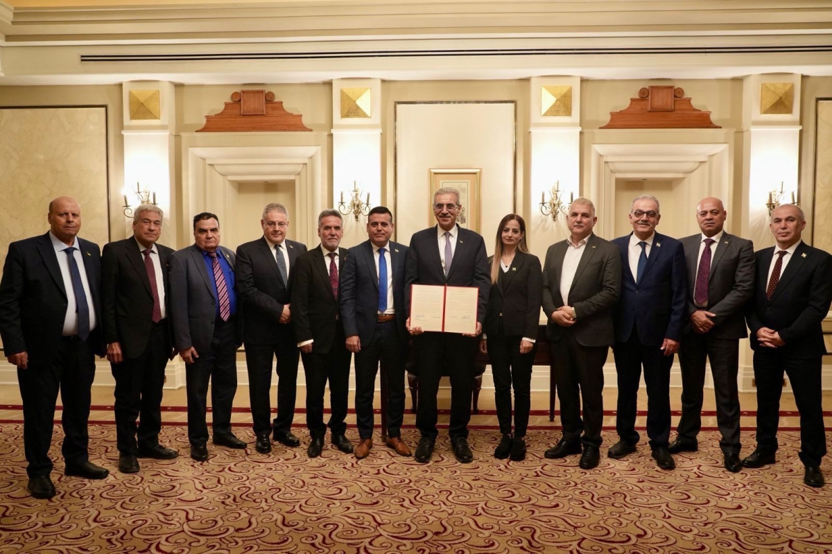 شعث متوسطاً أعضاء اللجنة بعد توقيع بيان مهمتها في القاهرة