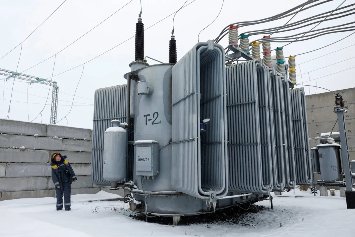 موظف في شركة طاقة يتفقد محولاً كهربائياً بعد أن ألحقت ضربات روسية أضراراً بالغة بالبنية التحتية المدنية الحيوية في كييف (رويترز)