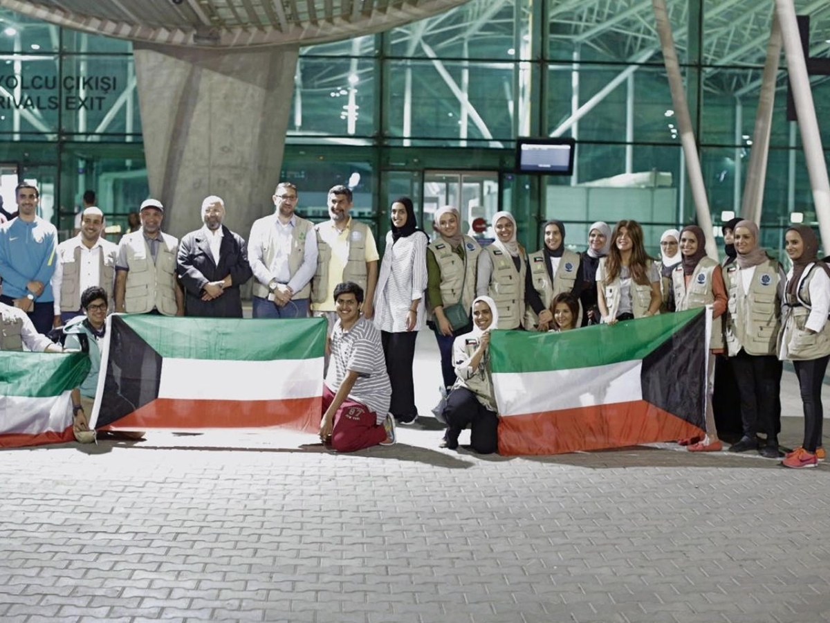 متطوعون يحيطون بعَلم الكويت